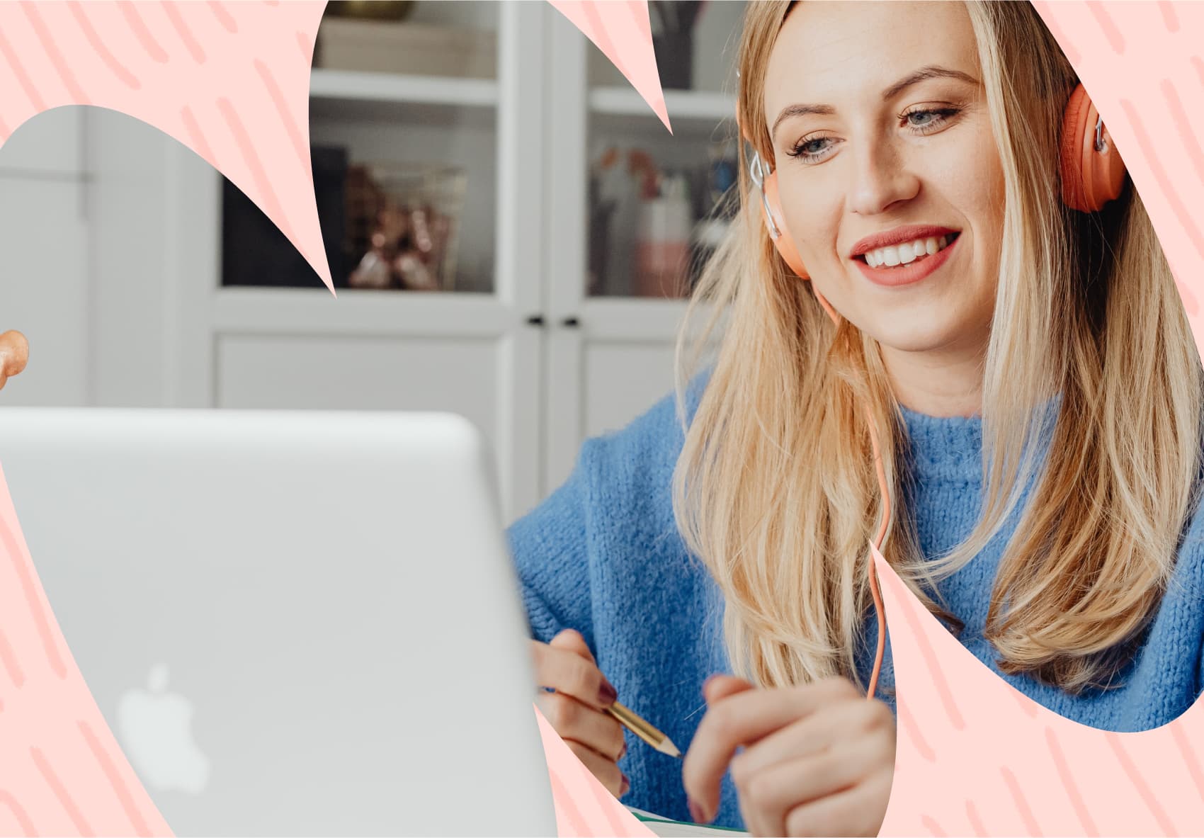 Smiling woman with headphones on, sitting in front of a laptop