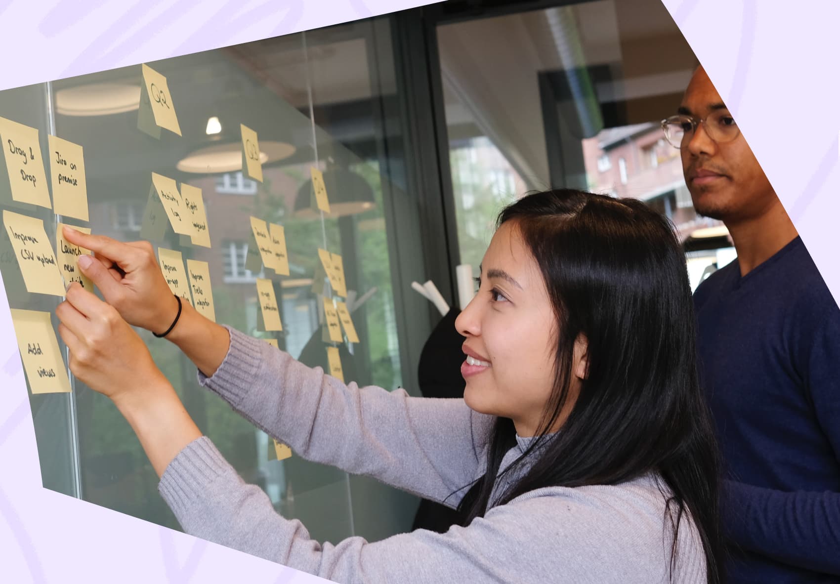 Woman arranging post-it notes on wall