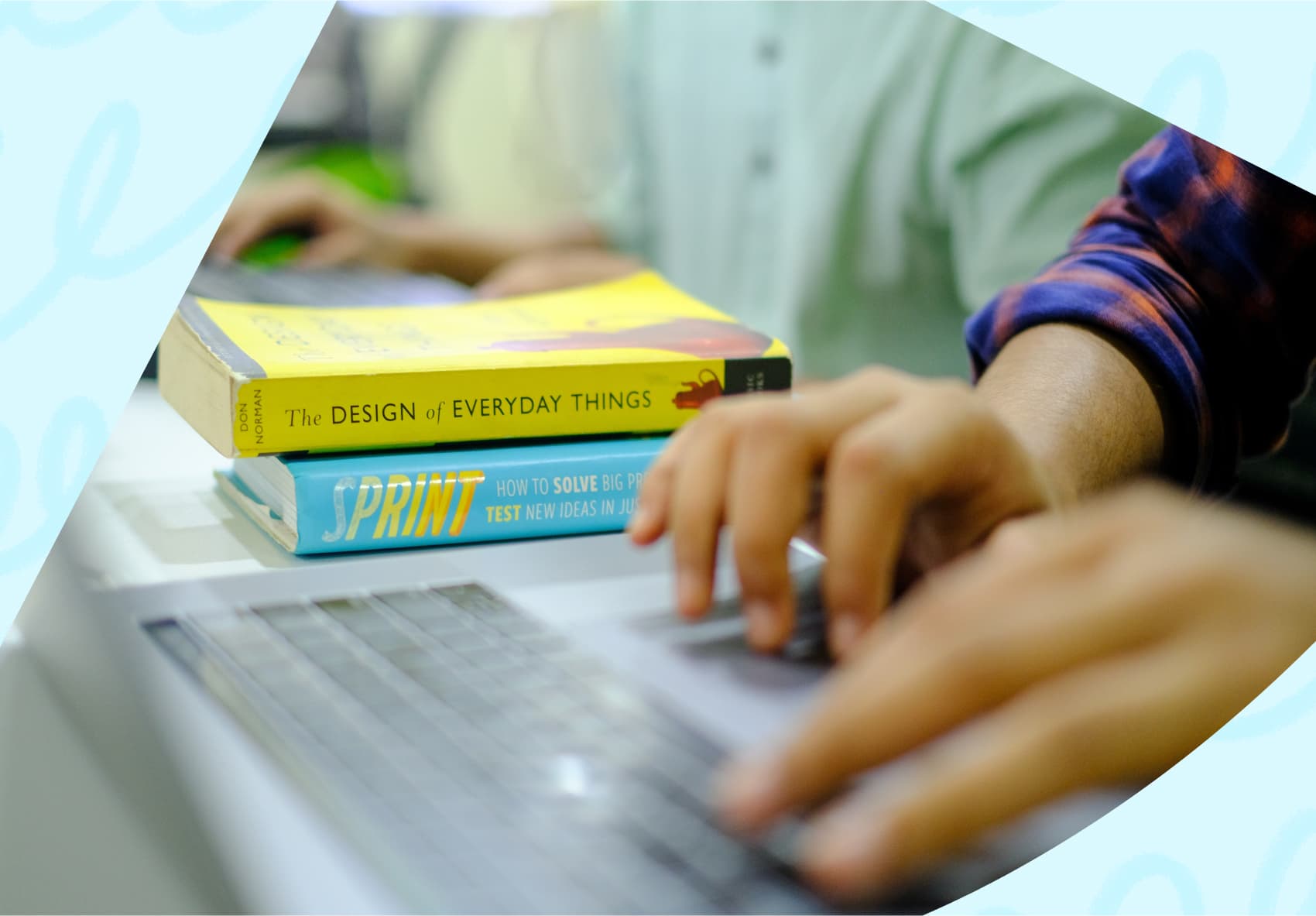 Two design books - The design of everyday things and Sprint stacked on top of each other on a desk.