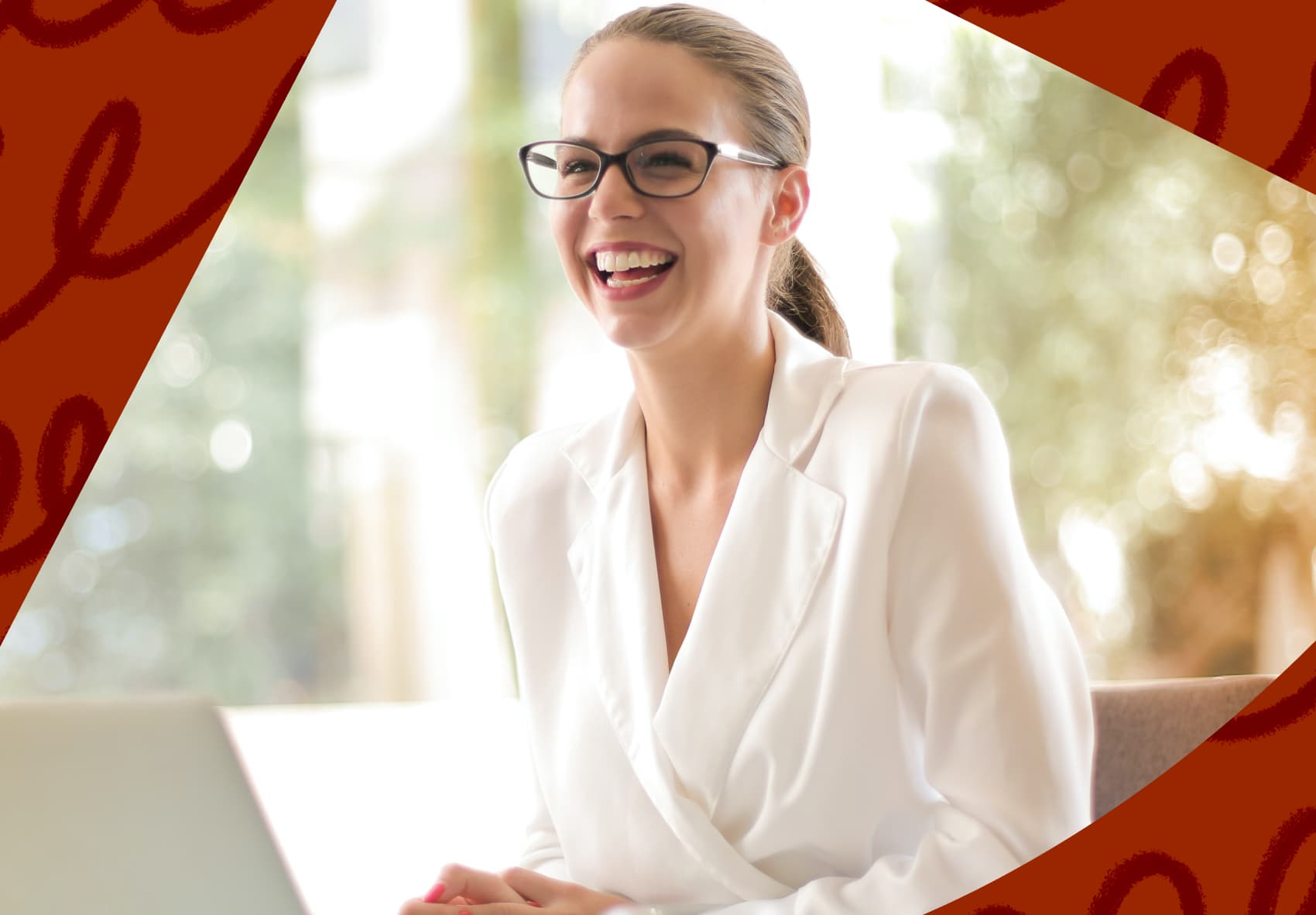 Smiling woman sitting in front of a laptop