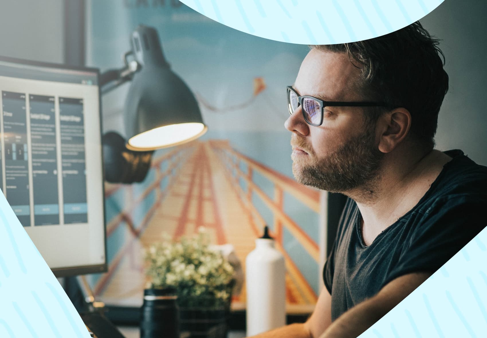 Man sitting at desk in front of computer screens