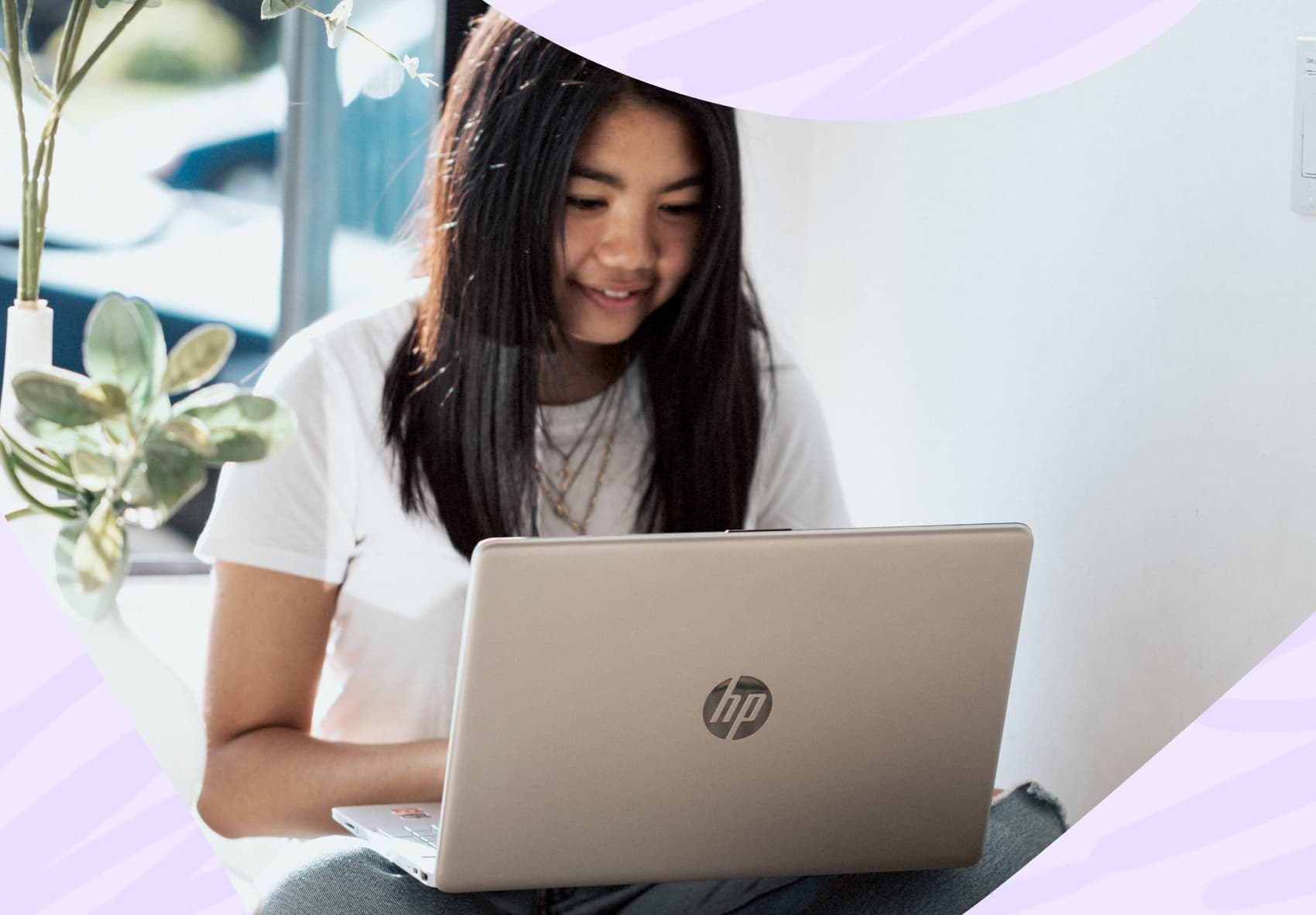 Smiling woman sitting in front of a laptop