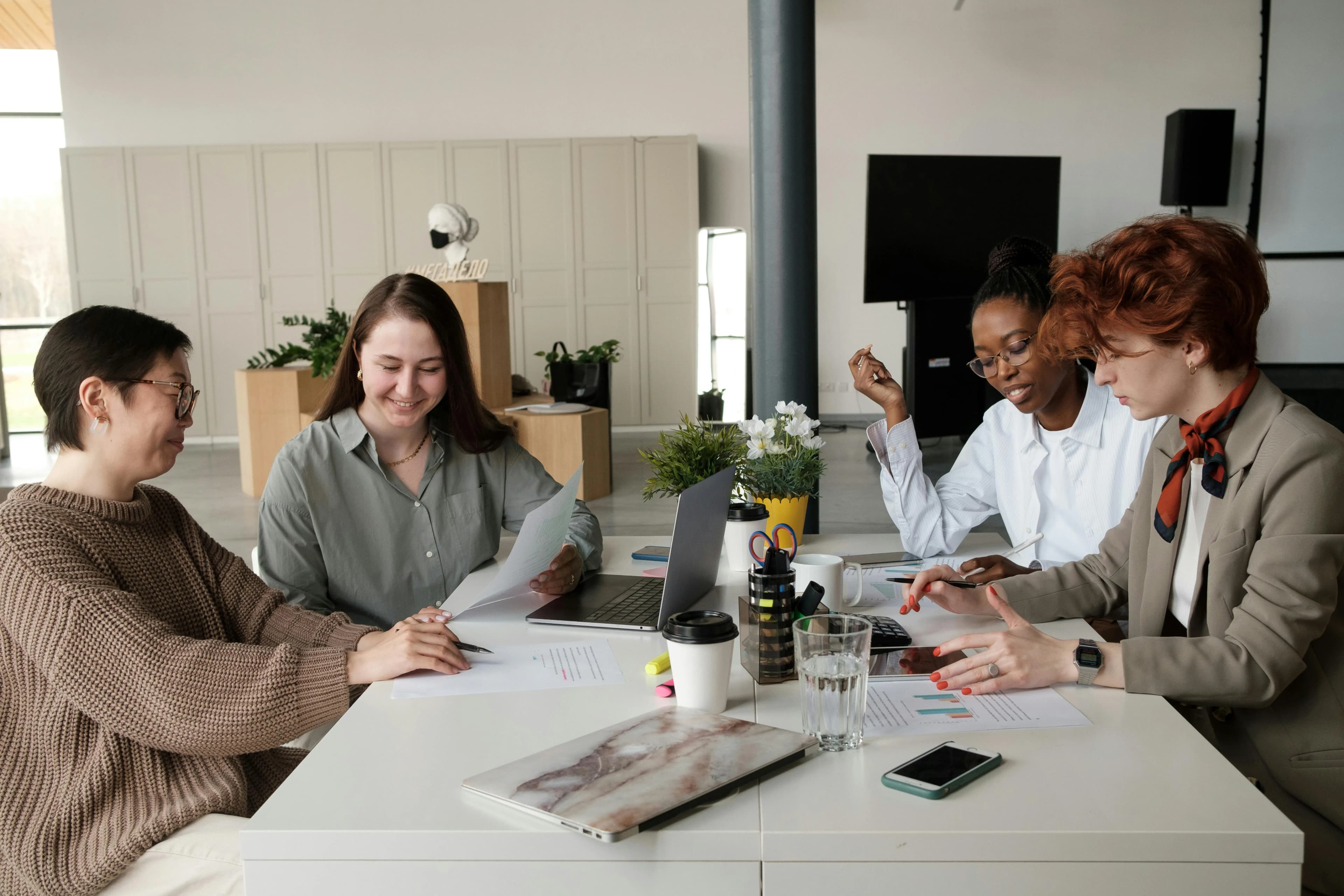 A group of work colleagues chatting and sitting around a table